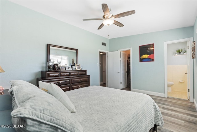 bedroom with visible vents, ensuite bathroom, ceiling fan, light wood-type flooring, and baseboards