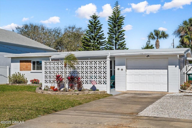 view of front facade with a front lawn, driveway, and an attached garage