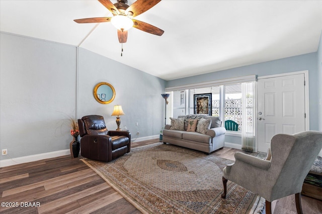 living room with lofted ceiling, wood finished floors, a ceiling fan, and baseboards