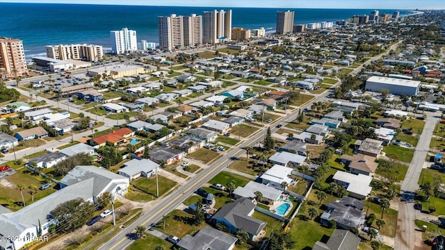 drone / aerial view featuring a view of city and a water view