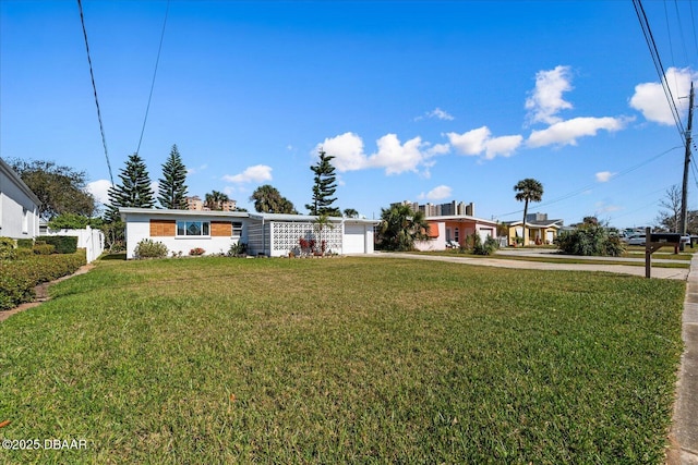 ranch-style house with a garage, fence, a front lawn, and concrete driveway