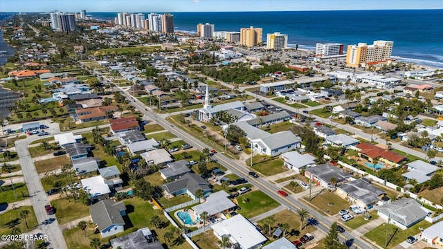 birds eye view of property with a water view and a city view