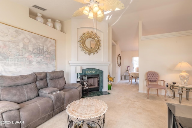 carpeted living room featuring ceiling fan and a fireplace