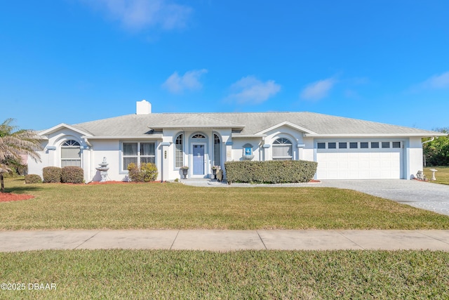 single story home with a garage and a front lawn