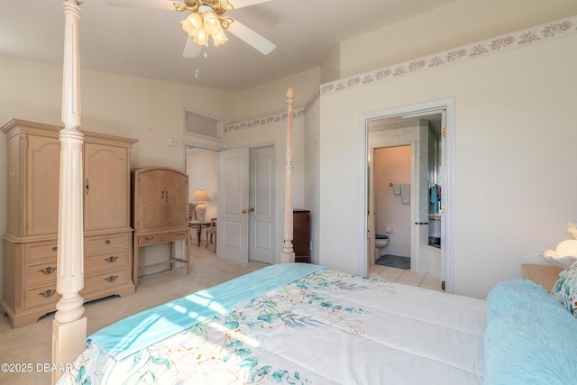 bedroom with connected bathroom and light colored carpet