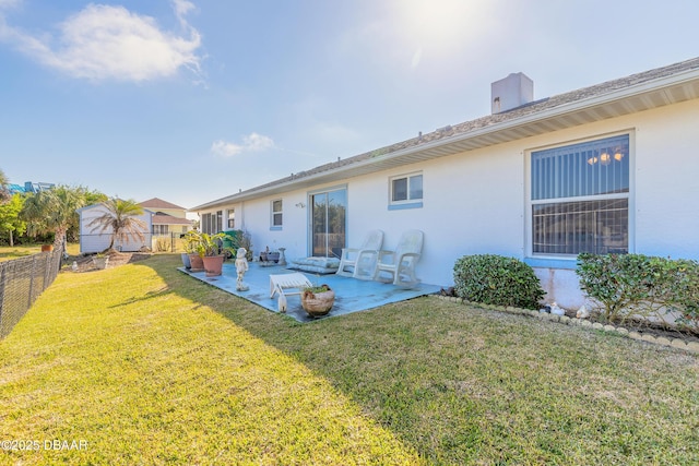 back of property featuring a patio and a lawn