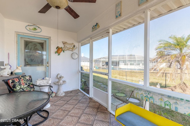 sunroom featuring ceiling fan