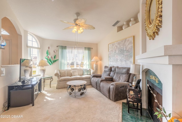 carpeted living room with ceiling fan, lofted ceiling, and a wealth of natural light