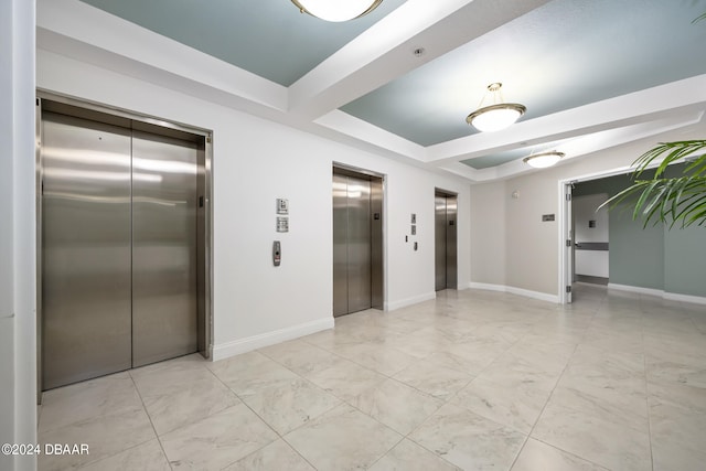 spare room with a raised ceiling and elevator