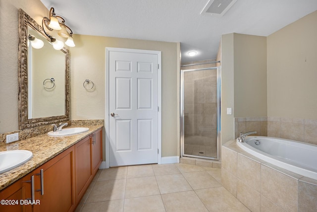 bathroom with vanity, separate shower and tub, tile patterned floors, and a textured ceiling