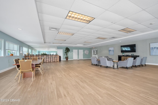 2 Oceans W Blvd Unit 707, Daytona Beach, FL 32118 - dining room featuring baseboards, light wood-style floors, and a drop ceiling