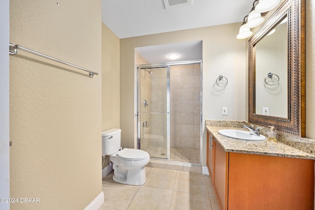 bathroom with an enclosed shower, vanity, tile patterned floors, and toilet