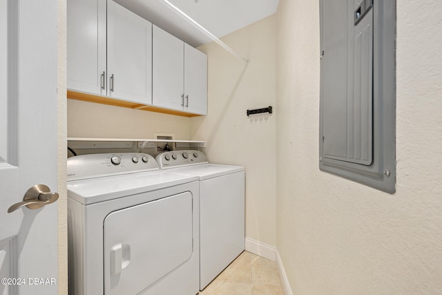 laundry room featuring cabinets, electric panel, independent washer and dryer, and light tile patterned flooring