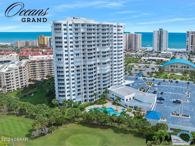2 Oceans W Blvd Unit 707, Daytona Beach, FL 32118 - drone / aerial view of a nearby body of water, apartment complex / building, a pool area, and a golf club