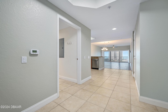 2 Oceans W Blvd Unit 707, Daytona Beach, FL 32118 - hall with a chandelier, baseboards, light tile patterned floors, electric panel, and a textured wall