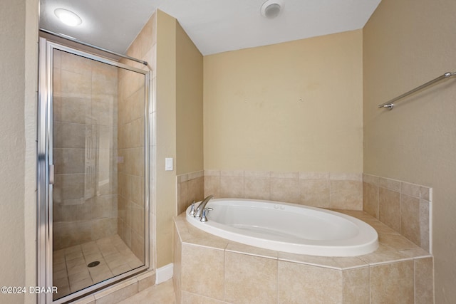 bathroom featuring separate shower and tub