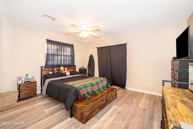 bedroom with light hardwood / wood-style floors and ceiling fan