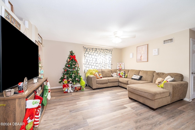 living room featuring hardwood / wood-style flooring and ceiling fan