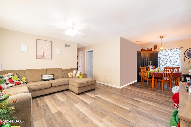 living room with hardwood / wood-style floors and ceiling fan