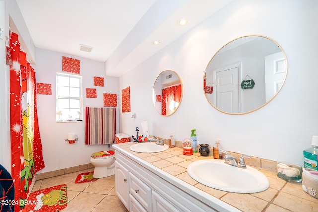 bathroom featuring tile patterned flooring, vanity, and toilet