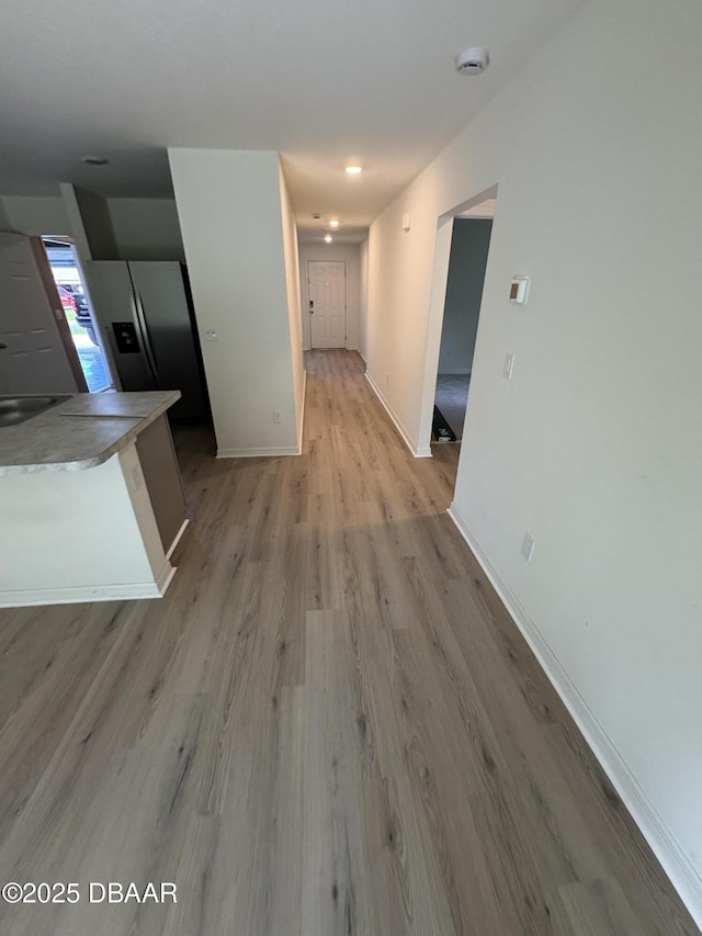 31 Palm Leaf Ln, Palm Coast, FL 32164 - hall featuring light wood-type flooring and baseboards