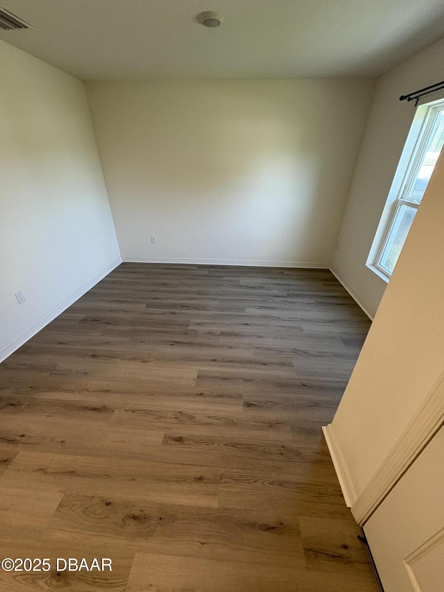 31 Palm Leaf Ln, Palm Coast, FL 32164 - spare room featuring wood finished floors and baseboards