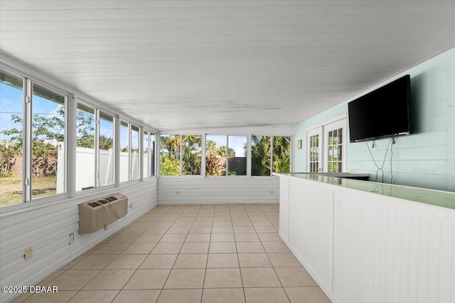 unfurnished sunroom featuring a healthy amount of sunlight and a wall mounted AC