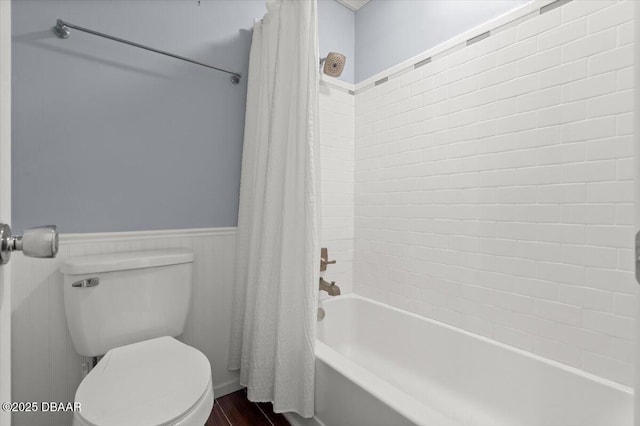 bathroom with toilet and shower / bath combo with shower curtain