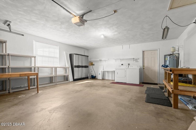 garage featuring a garage door opener, washing machine and dryer, electric water heater, and a workshop area