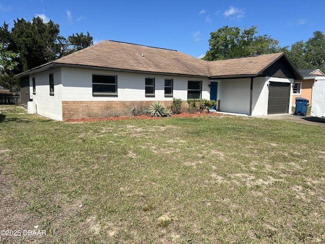 ranch-style house featuring a garage and a front lawn