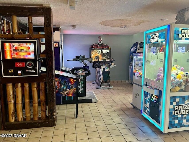 game room with tile patterned floors and a textured ceiling