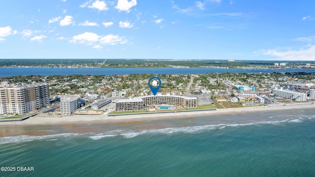 drone / aerial view featuring a water view and a beach view