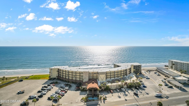 bird's eye view featuring a water view and a beach view