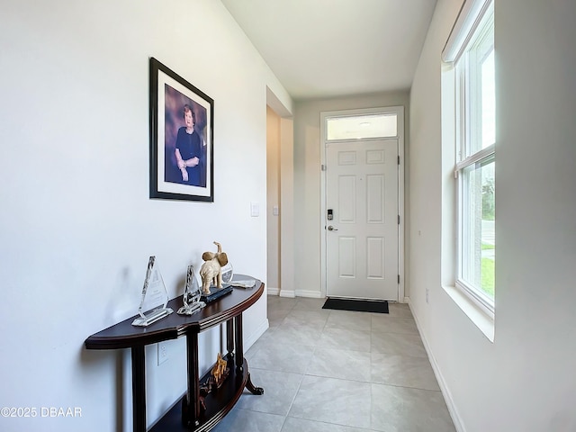 doorway with light tile patterned flooring