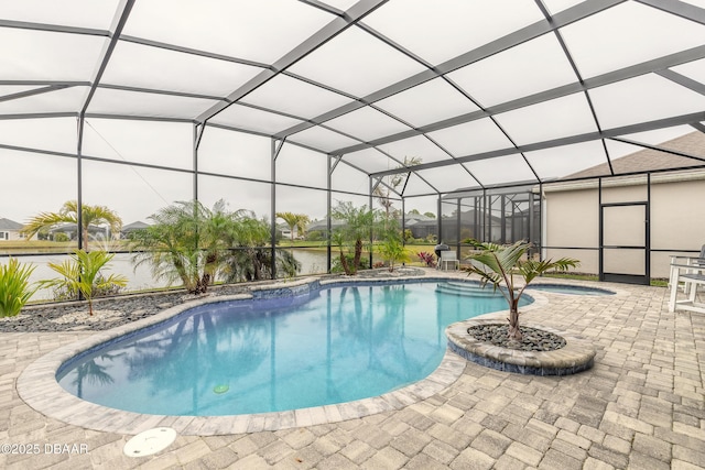 view of pool with a patio, an in ground hot tub, glass enclosure, and a water view