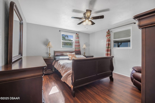 bedroom with ceiling fan and dark hardwood / wood-style flooring