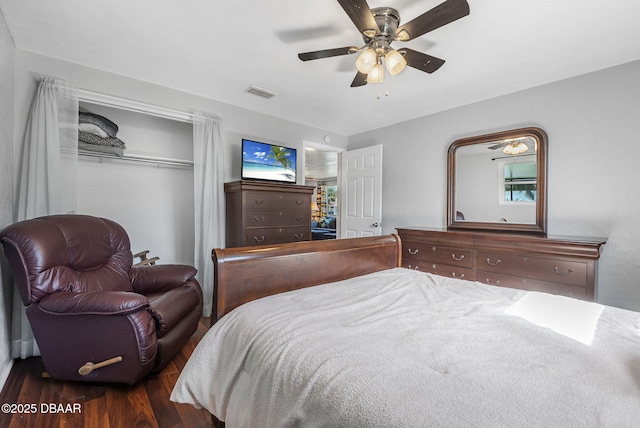 bedroom with dark hardwood / wood-style floors and ceiling fan