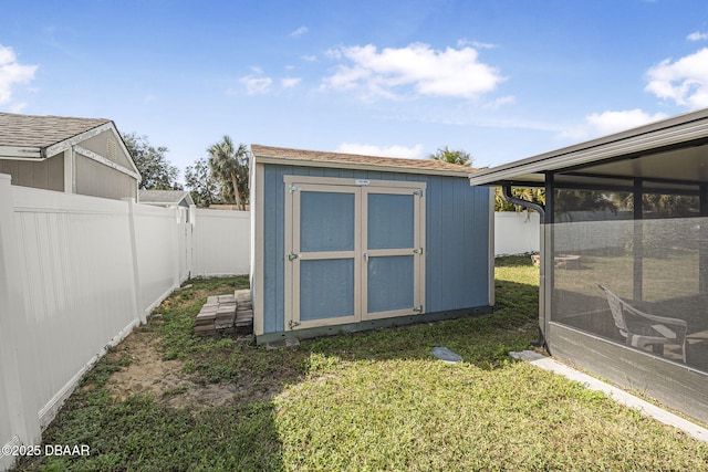 view of outbuilding featuring a sunroom and a yard