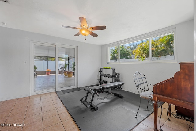 workout room featuring light tile patterned floors and ceiling fan