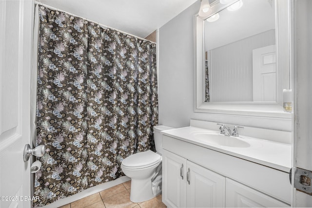 bathroom featuring vanity, tile patterned floors, and toilet