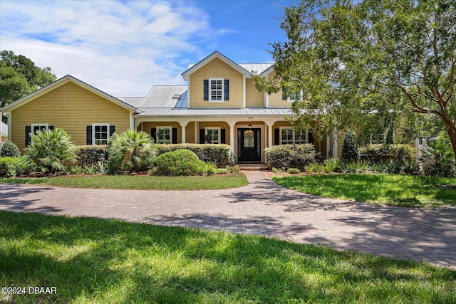 view of front of house with covered porch and a front lawn