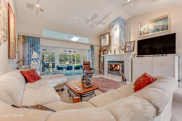 67 Kingsley Ln, Ormond Beach, FL 32174 - living room with carpet flooring, ceiling fan, a fireplace, rail lighting, and high vaulted ceiling