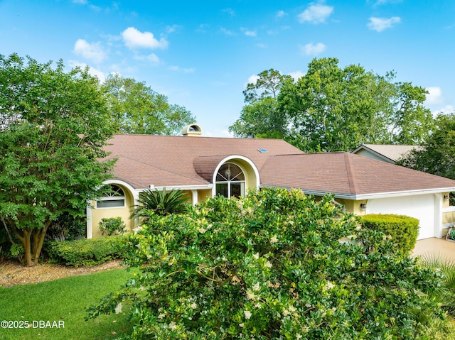 67 Kingsley Ln, Ormond Beach, FL 32174 - view of front of house with a shingled roof, an attached garage, and stucco siding