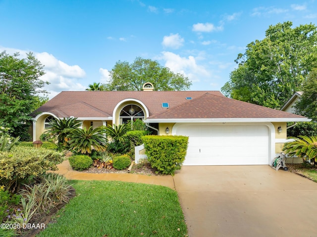 67 Kingsley Ln, Ormond Beach, FL 32174 - view of front facade with an attached garage, roof with shingles, stucco siding, and concrete driveway