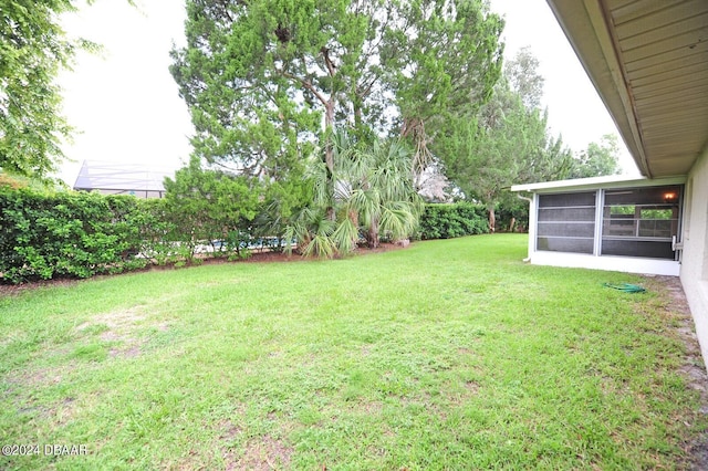 view of yard with a sunroom