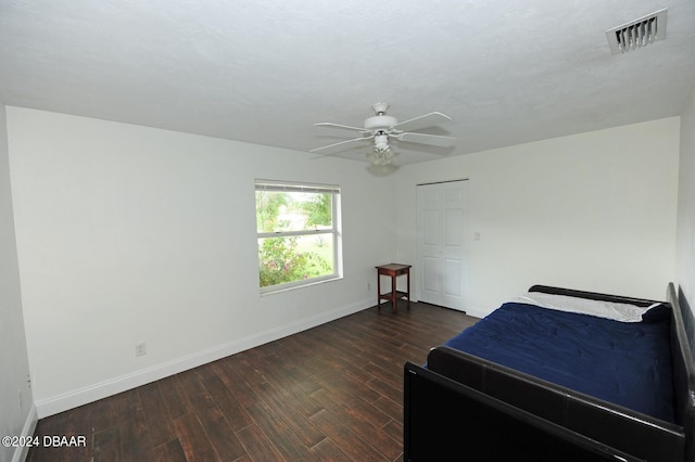 bedroom featuring dark hardwood / wood-style flooring and ceiling fan