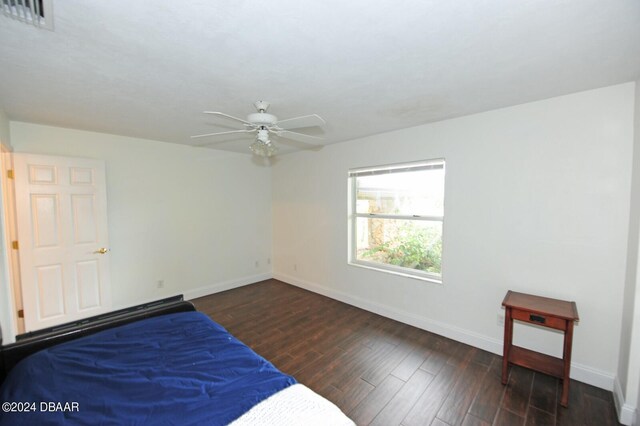1889 Seclusion Dr, Port Orange, FL 32128 - bedroom featuring baseboards, wood finished floors, and a ceiling fan