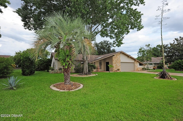 single story home featuring a garage and a front lawn