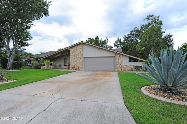 1889 Seclusion Dr, Port Orange, FL 32128 - mid-century home with an attached garage, stone siding, driveway, a front lawn, and stucco siding
