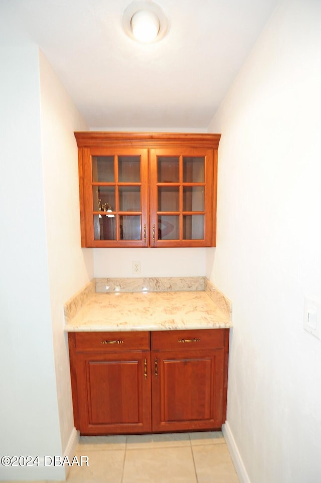 kitchen with light stone counters and light tile patterned flooring